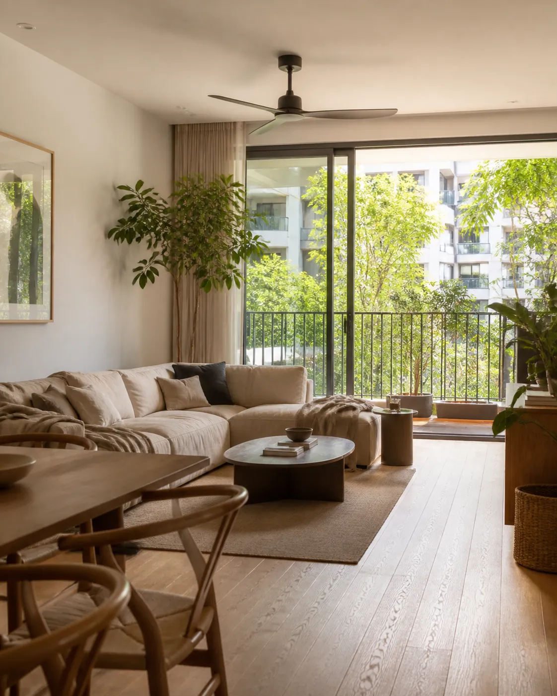 A contemporary condominium living and dining room with full height doors open to a balcony.