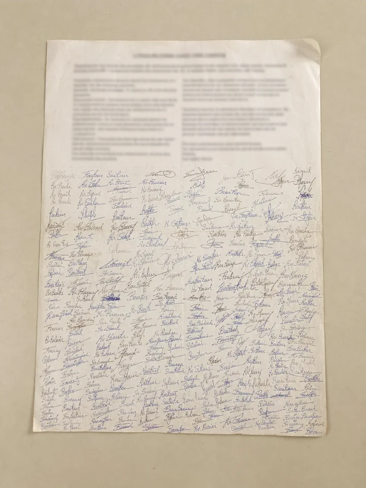 A typed petition letter with signatures filling both margins.